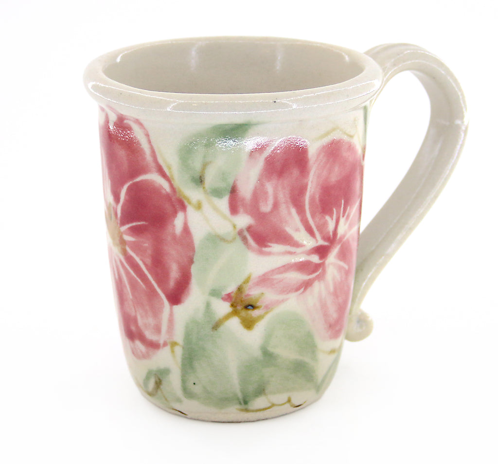 Coastal themed pottery high fire stoneware mug with a floral pattern of reddish pink flowers and teal green leaves