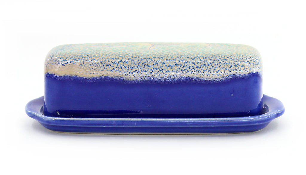 Stoneware butter dish featuring a Sea Foam Blue glaze which presents as a white speckled wash over cobalt blue--side view